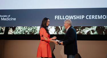 Fellow receiving Fellowship certificate
