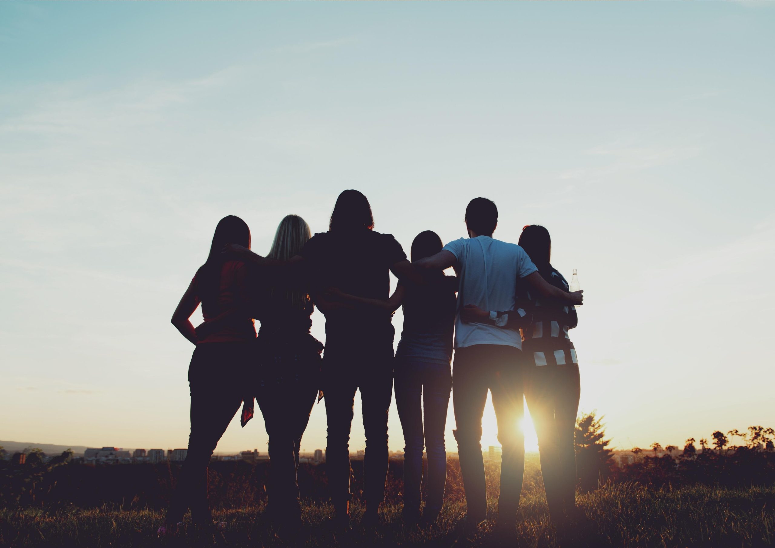 Group of friends in front of sun