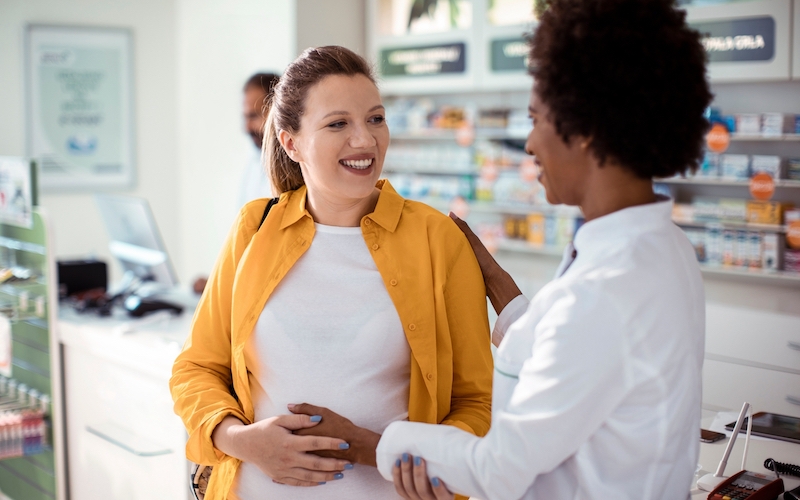 Community pharmacist assisting patient