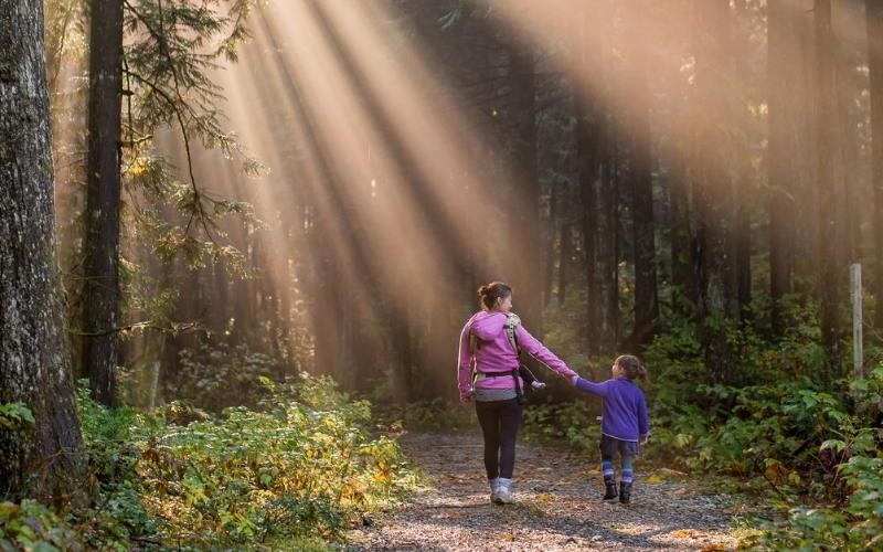 Woman and child walking on gravel path