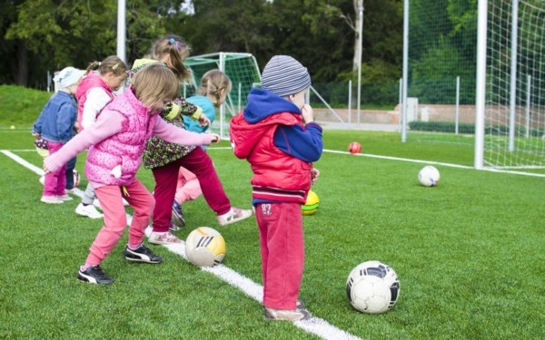 Kids kicking soccer balls