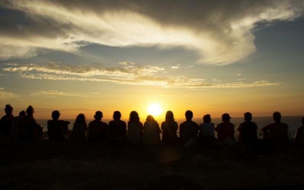 Group of people looking at sunset