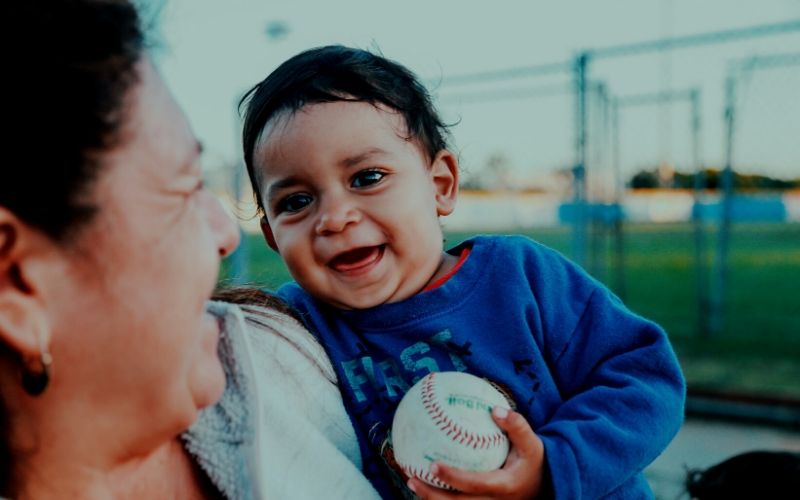 Child and parent with baseball
